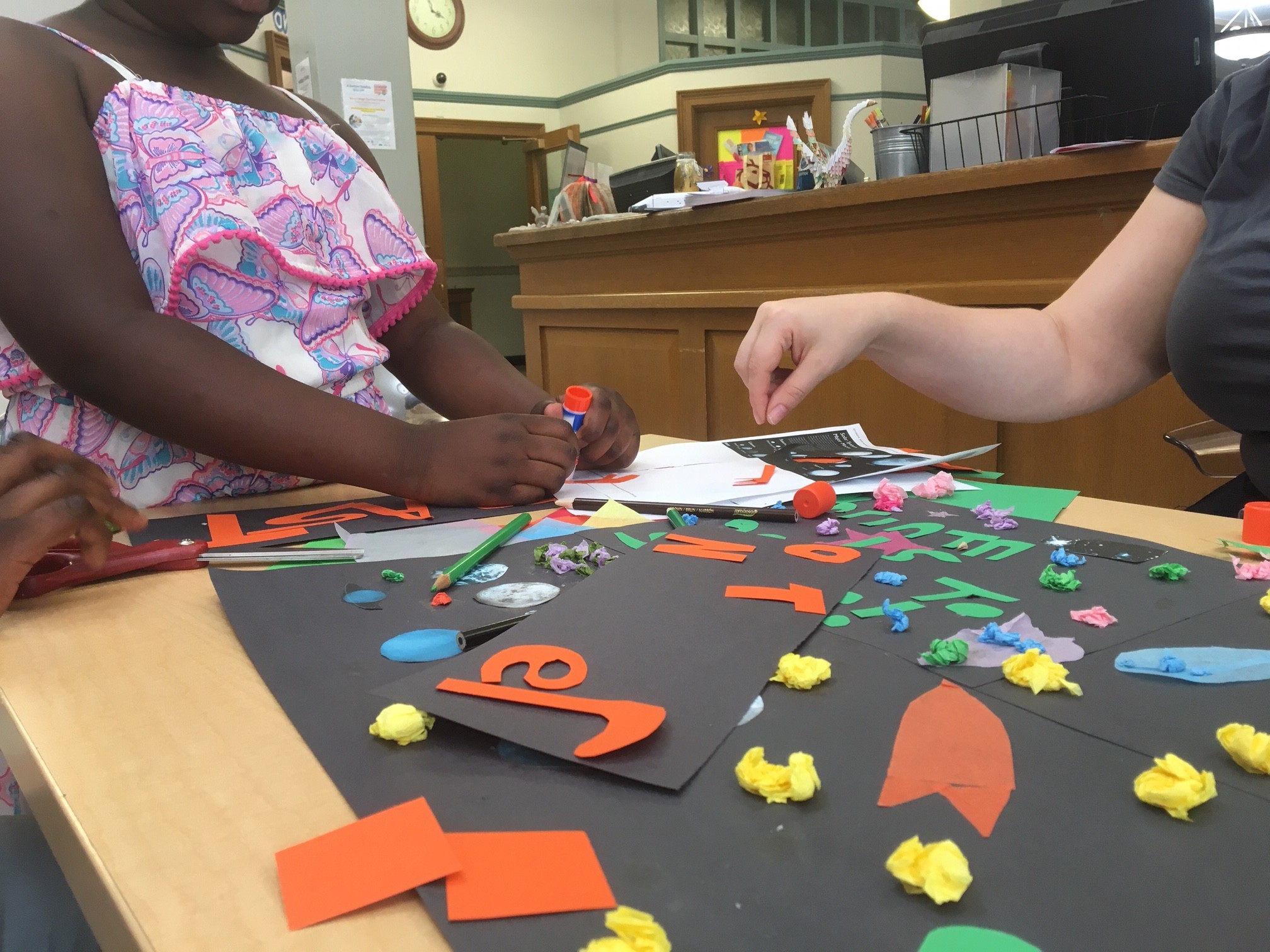 Youth and librarians at Seward Park Library blasted off into space with this collage poster. 